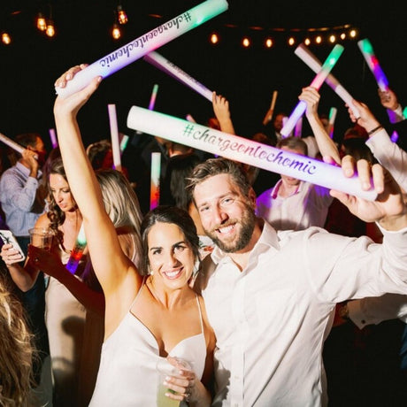 a man and a woman are holding up some lights
